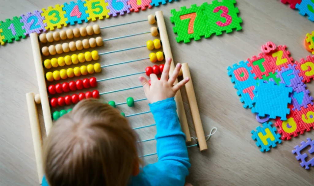 Child playing with abacus- Child Care Subsidy- How 3-Day Guarantee Helps Families
